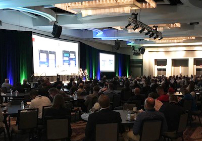 Conference room filled with people looking at a presentation