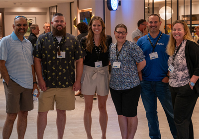6 people standing and smiling