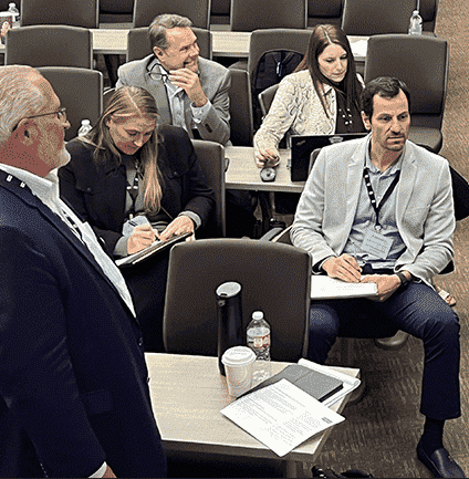 <img src=_blog-box-ideation-10-2023.html alt="four people sitting in chairs and one person standing">